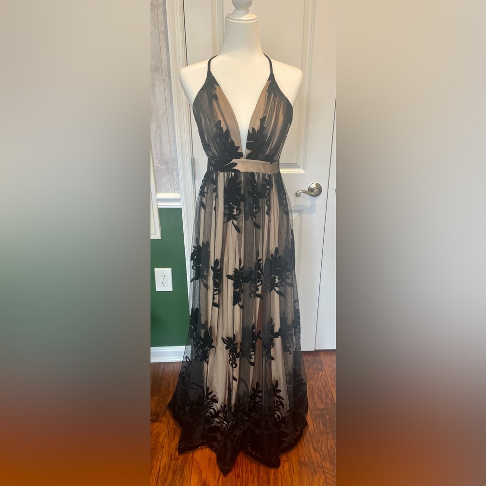 This floor length formal dress has a velvet finish and includes a nude slip.
